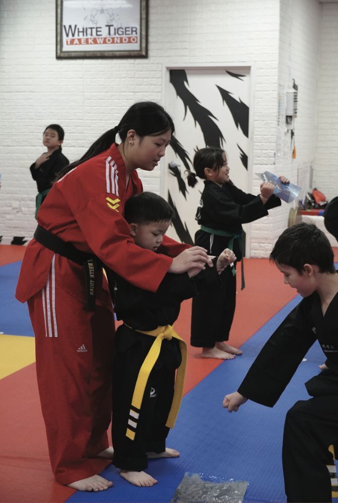 Sophomore Claire Kim teaches students at her parents’ taekwondo studio, Kim’s White Tiger. She has been doing taekwondo since she was 3.